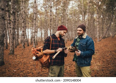 Two Millennial Man Hiking And Drinking Beer In A Pine Forest, Laughing And Having Fun.