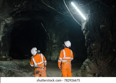 Two miners observing the cavern