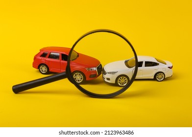 Two Mini Toy Car Crash Through Magnifying Glass On Yellow Background, Incident, Car Traffic Accident