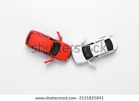 Two mini toy car crash on white background, incident, car traffic accident. Top view