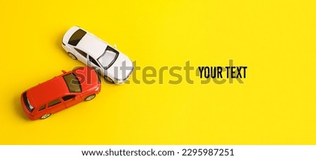 Two mini toy car crash on a yellow background, incident, car traffic accident. Copy space
