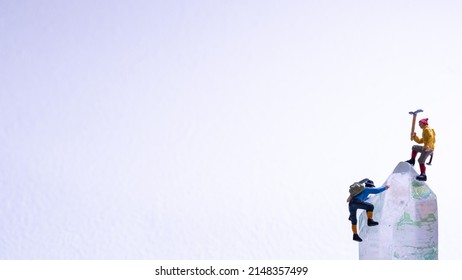 Two miniature climbing in snowy mountains