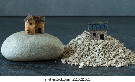 Two miniature houses, one built on a rock, and the other built on a sand. Jesus Christ parable of wise and foolish Christian. The biblical concept of faith and obedience to God. A close-up.