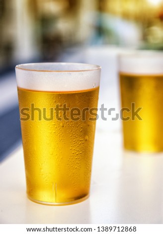 Two misted plastic beer cups outdoor