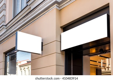 Two mock ups of restaurant white  modern rectangular street signboards on yellow wall
