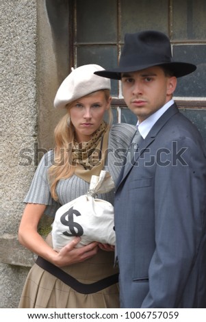 Two models get dressed up in 1930's style 
vintage fashion clothes and act the role of 
the gangster duo Bonnie and Clyde.
