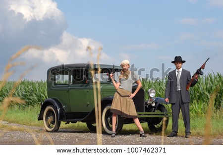 Two models get dressed up in 1930's style vintage fashion clothes and act
the role of the gangster duo Bonnie and Clyde.