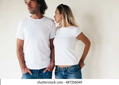 Two Models Man And Woman Wearing Blanc T-shirt Posing Against White Wall, Toned Photo, Front Tshirt Mockup For Couple