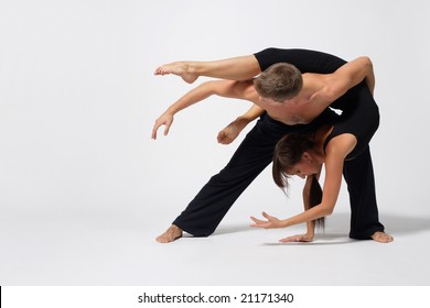 Two Modern Ballet Dancers Posing On White