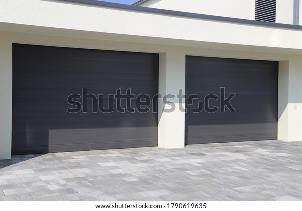 Two modern new\
garage doors (sectional\
doors)