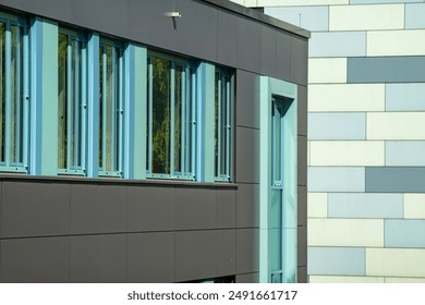 two modern, rectangular blue grey buildings
