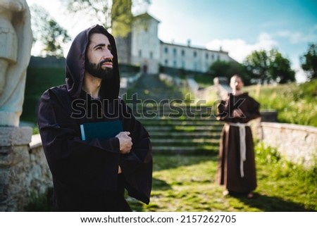 Two monks outside the monastery pray. Hope for a better world.