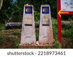 Two monoliths that indicate different places to follow the Camino de Santiago. Photography made in Pontevedra, Galicia, Spain.