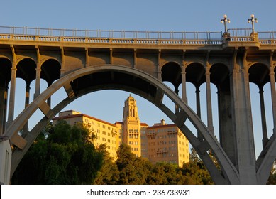 Two of the most recognized Pasadena, California landmarks: The building houses the US Ninth Circuit Court of Appeals. The arch is one segment of the Colorado Street Bridge which spans the Arroyo Seco. - Shutterstock ID 236733931