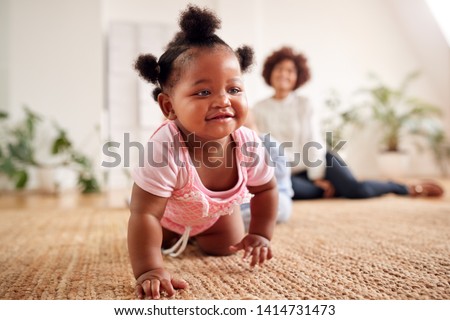Two Mothers Meeting For Play Date With Babies At Home In Loft Apartment