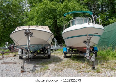 two motor boats on trailers at parking