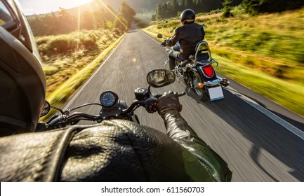 Two Motorbikers Riding On Empty Road With Sunrise Light, Concept Of Speed And Travel In Nature