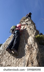 Two Mountaineers Doing A Via Ferrata In Andorra