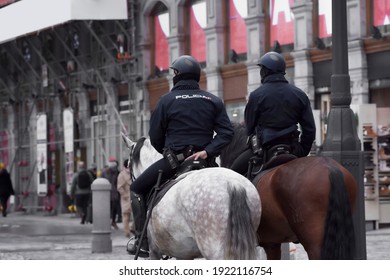 Two Mounted Police Officers On Horseback In The Center Of Madrid, Spain.