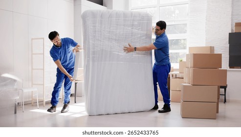Two Movers Delivering White Sofa To Happy Customer's New Home