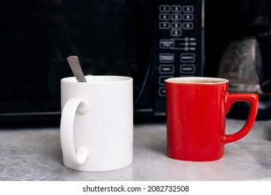 Two mugs on the kitchen table close up