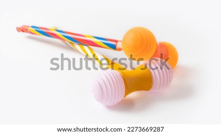 Two multicolored plastic toy hammers on white background