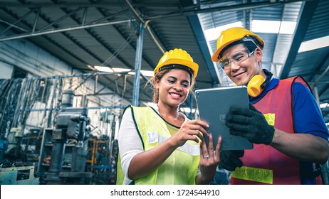 Two multiethnic industrial workers looking at tablet in the warehouse. - Powered by Shutterstock