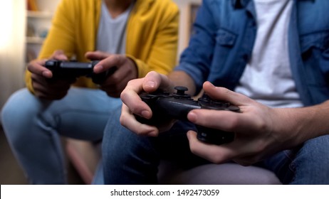 Two Multiethnic Teenage Boys Playing Computer Games At Home, Hands Close-up