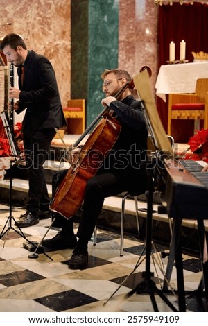 Two musicians play wind and string instruments inside a beautifully decorated church. The atmosphere is serene, with soft lighting and festive decorations enhancing the ambiance.