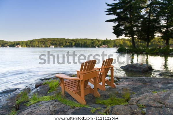 Two Muskoka Chairs Sitting On Rock Stock Photo Edit Now