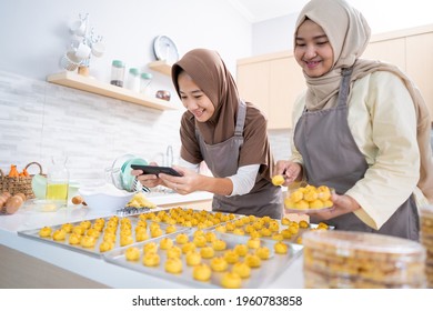 Two Muslim Woman Taking Picture Of The Food Product They Made At Home. Small Business Muslim Selling Nastar Cake For Eid Mubarak