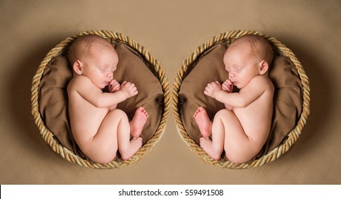 Two Naked Newborn Baby Baskets Sleeping In The Fetal Position