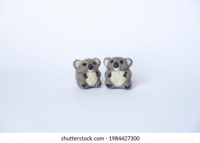 Two Needle Felting Koala On Isolated White Background.