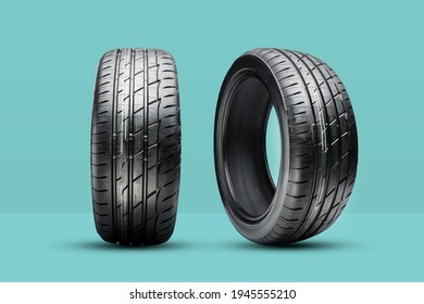 two new summer tires on a green background