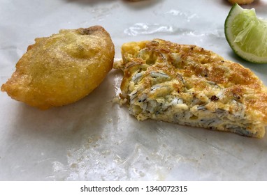 Two New Zealand Culinary Delights; A Bluff Oyster And A Whitebait Fritter.