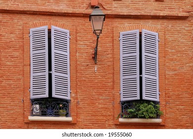 Two nice windows on the brick wall