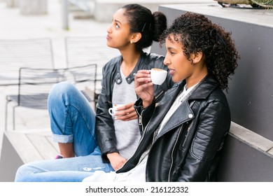 Two North African Teen Friends Drinking Together Coffee Outside 