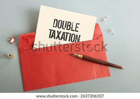 two notepads. open notepad with text DOUBLE TAXATION