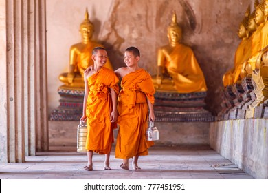 Two novices monk walking and talking in old temple at Ayutthaya Province, Thailand.
