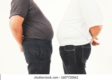 
Two Obese Men Stand Side By Side, Compare Their Stomach Size, Full Of Excess Fat, And Are Happy With Their Bodies And Health, Both Of Them Fat.