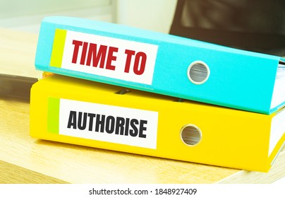 Two office folders with text TIME TO AUTHORISE