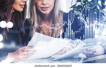 Two office women using tablet, holding business report. Double exposure with graphs dynamics and numbers, rising candlesticks. Concept of financial analysis and cooperation - Powered by Shutterstock