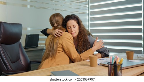 Two Office Workers Talking About Failure In Recent Project Hugging To Support. Friend Sharing Bad News About Family Members.