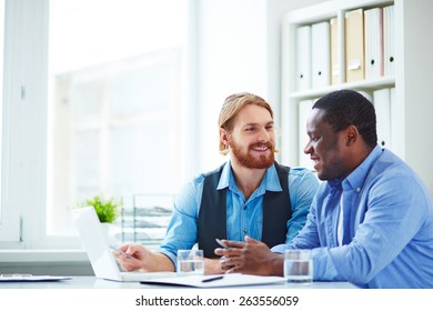 Two Office Workers Talking About Business