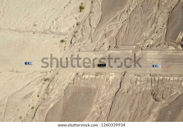 Two\
Off-road vehicles on desert road - Aerial\
image