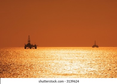 Two offshore oil rigs during sunset  in Caspian sea