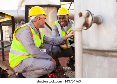 two oil chemical industry technicians working in plant