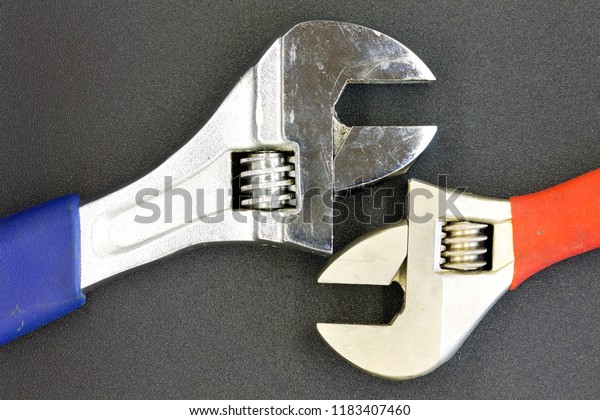 two old Adjustable wrench/ background image\
wrenches on gray Adjustable\
wrench