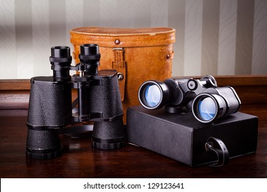 Two old binoculars on a table