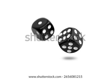 Two old black dice float from roll isolated on white background.